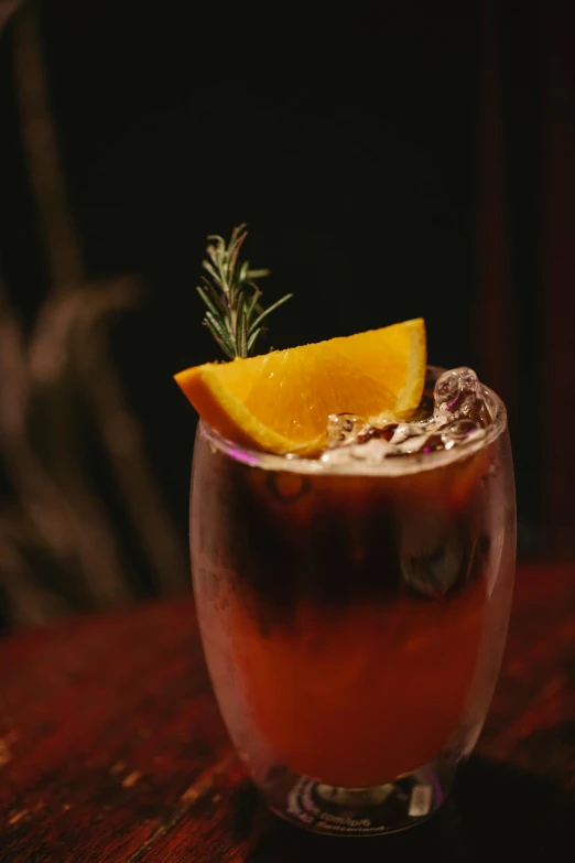 a drink sitting on top of a wooden table, profile image, black forest, dark orange, thumbnail