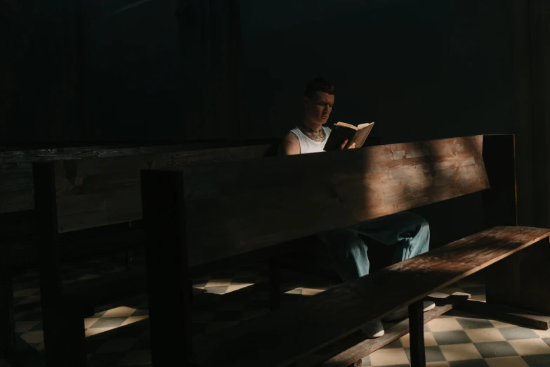 a man sitting on a bench reading a book, by Eglon van der Neer, pexels contest winner, mannerism, light glare, pews, teenage boy, 15081959 21121991 01012000 4k