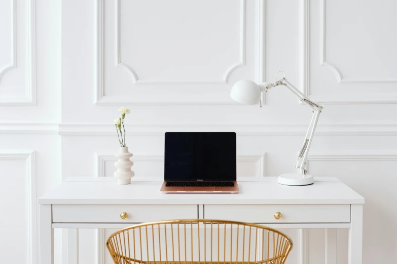 a laptop computer sitting on top of a white desk, by Julia Pishtar, gold and white, smooth panelling, white backdrop, background image