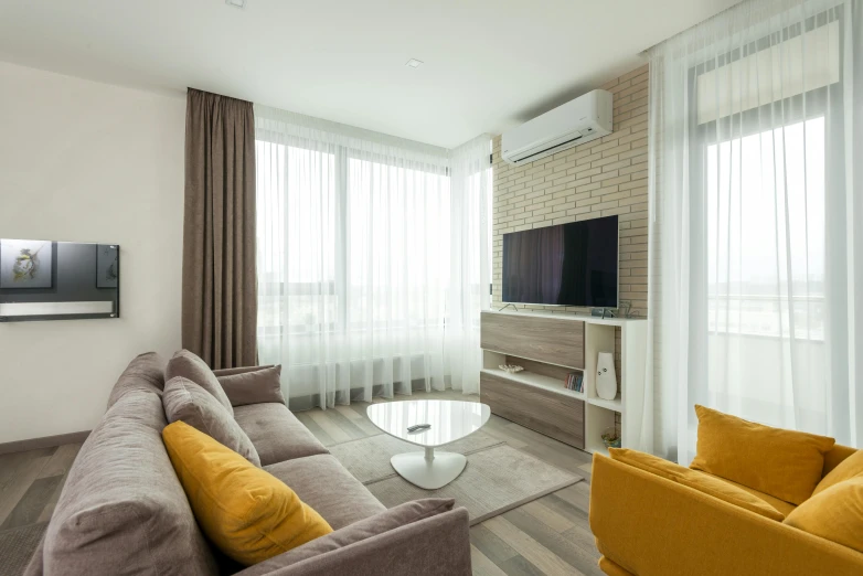 a living room filled with furniture and a flat screen tv, by Adam Marczyński, unsplash, light and space, white and yellow scheme, bright sky, red brown and grey color scheme, interior of a small room