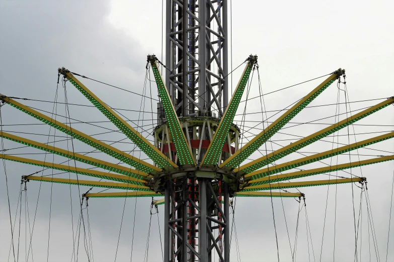 a close up of a carnival ride on a cloudy day, by Bradley Walker Tomlin, standing on the mast, huge support buttresses, photograph taken in 2 0 2 0, a green