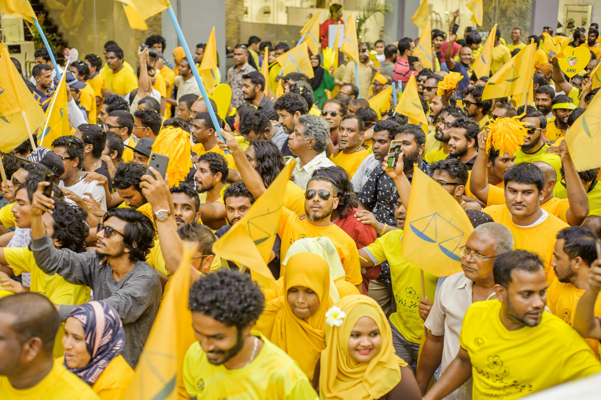 a large group of people holding yellow flags, hurufiyya, jayison devadas, thumbnail, high quality image