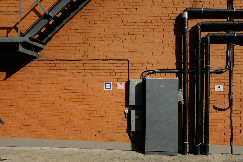 a fire hydrant on the side of a brick building, by Sven Erixson, unsplash, control panels, square, фото девушка курит, opposite the lift-shaft