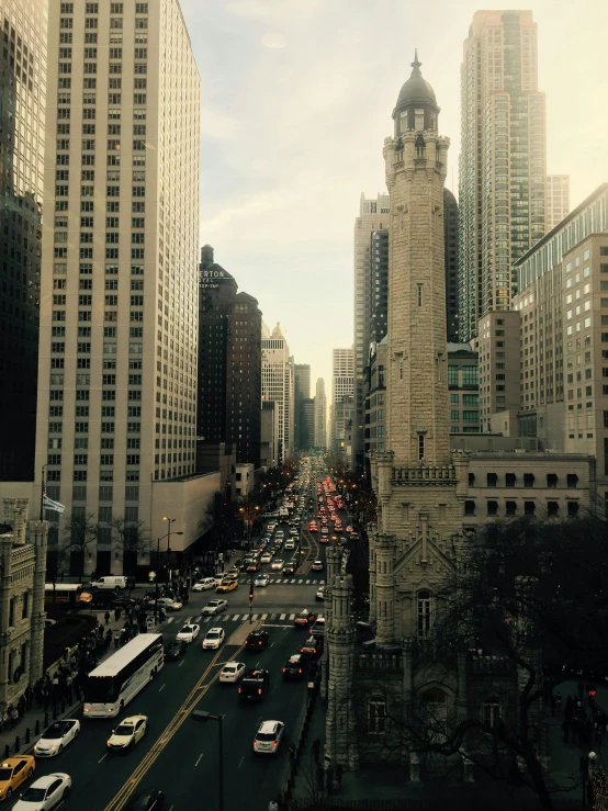 a city street filled with lots of traffic next to tall buildings, a photo, inspired by Thomas Struth, happening, chicago, instagram photo amazing view, 8k”