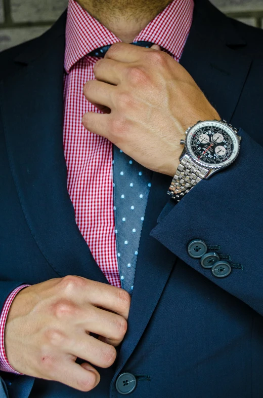 a man in a suit adjusts his tie, inspired by Harrington Mann, renaissance, breitling, wearing a watch, close up half body shot, colourful clothing