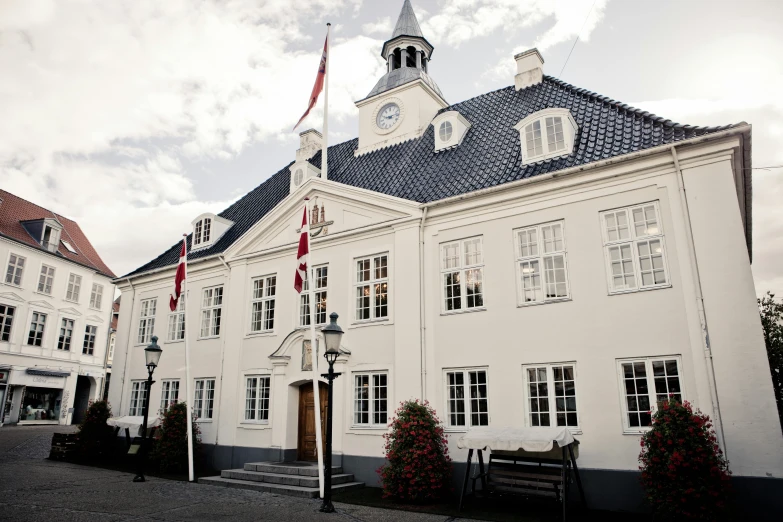 a large white building with a clock tower, by Jesper Knudsen, private academy entrance, flag, hammershøi, very ornate