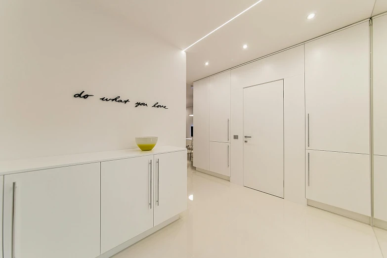 a white kitchen with a yellow bowl on the counter, inspired by Edward Okuń, unsplash contest winner, light and space, led light strips, infinite hallway, in white lettering, neo kyiv