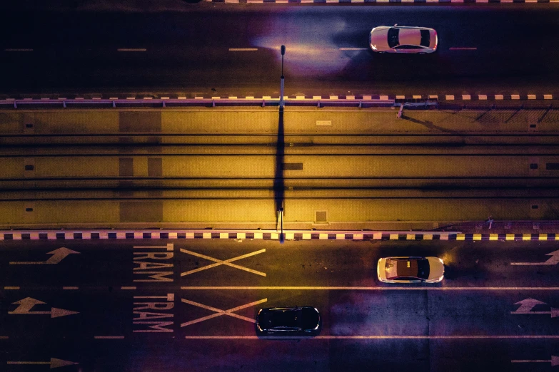 an overhead view of a city street at night, by Adam Marczyński, taxis, cinematic image, thumbnail, purple and yellow lighting