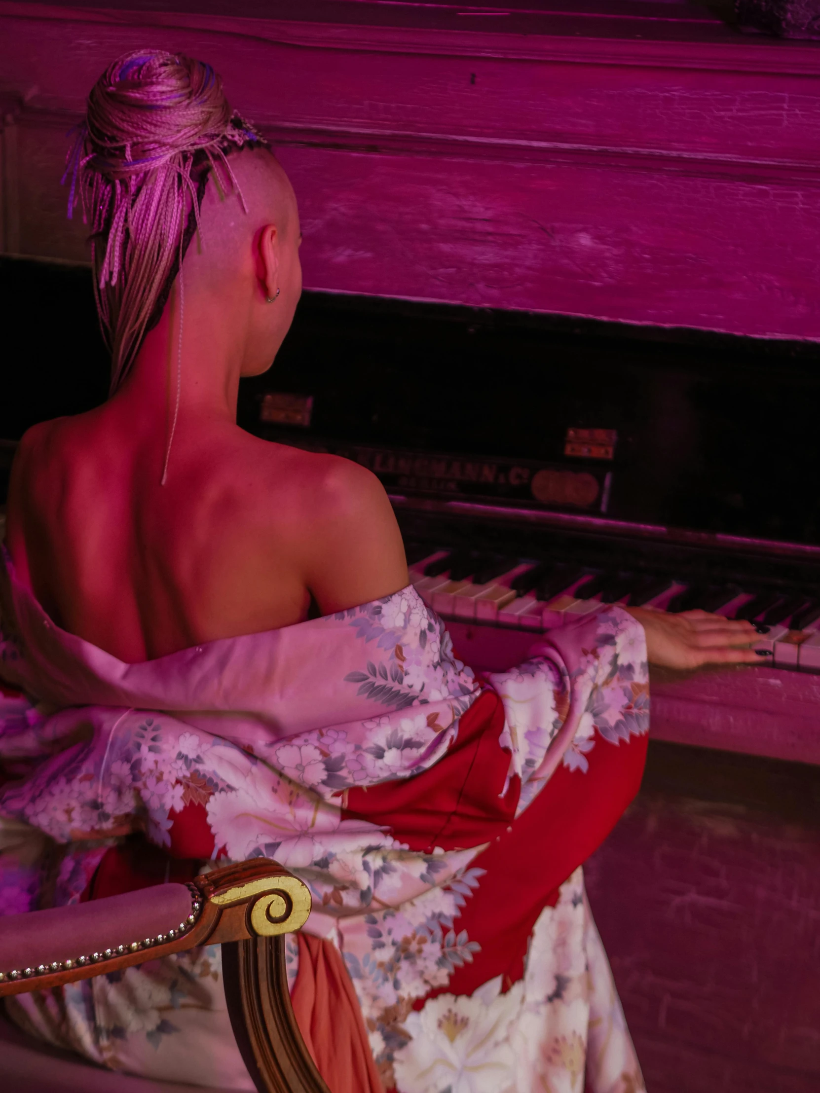 a woman sitting in front of a piano, an album cover, inspired by Elsa Bleda, unsplash, aestheticism, die antwoord yolandi visser, japanese kimono, barely lit warm violet red light, bare back