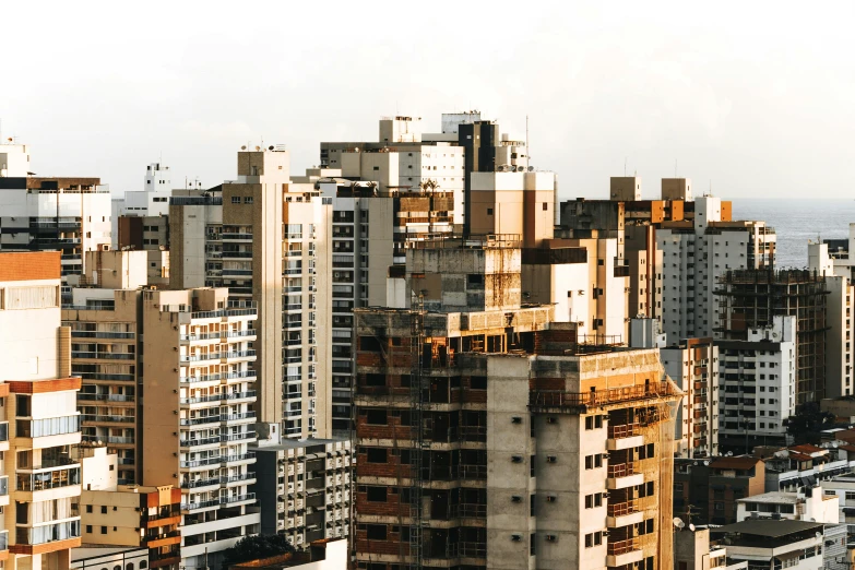 a group of tall buildings sitting next to each other, by Ceferí Olivé, roofs, brazilian, julia sarda, houses and buildings