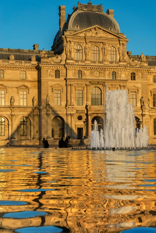 a large building with a fountain in front of it, a photo, inspired by Édouard Detaille, pexels contest winner, gold refractions off water, from louvre, late afternoon light, square