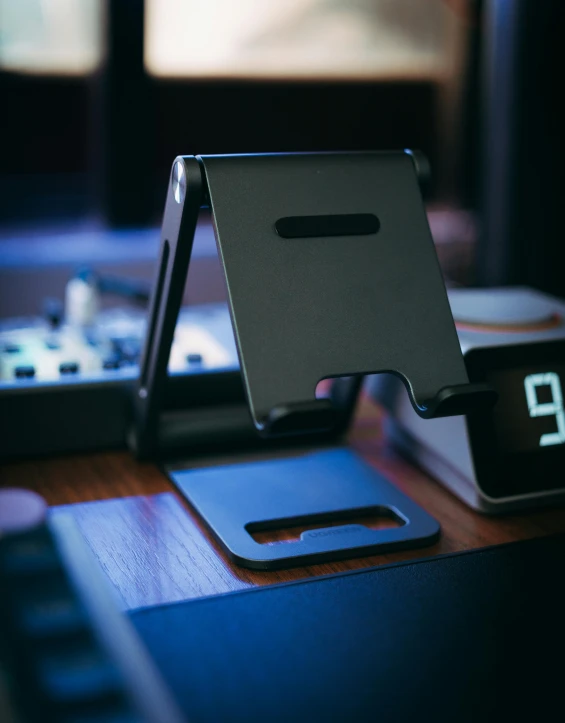 a clock sitting on top of a desk next to a laptop, by Android Jones, in gunmetal grey, with laser-like focus, battle stand, thumbnail