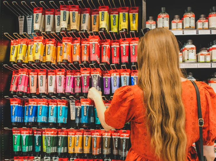 a woman standing in front of a vending machine, pexels contest winner, process art, molotow premium color palette, large jars on shelves, long blonde or red hair, holding paintbrushes