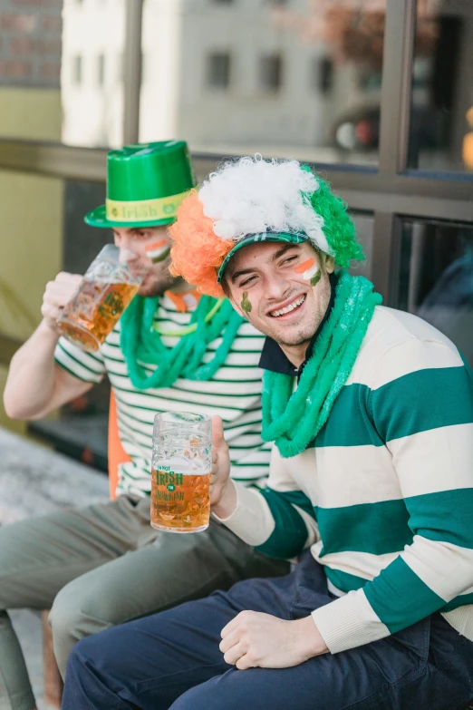 a couple of men sitting next to each other on a bench, irish, drinking their hearts out, green and orange theme, 🚿🗝📝