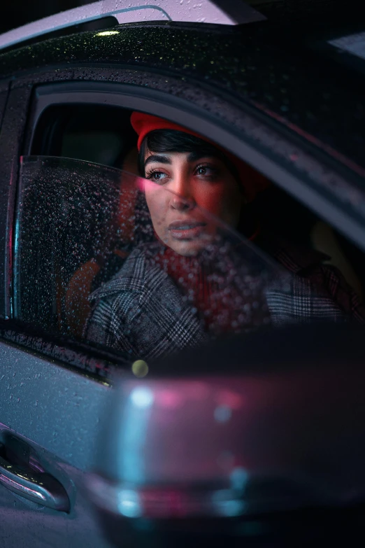 a woman sitting in the passenger seat of a car, an album cover, inspired by Elsa Bleda, left eye red stripe, winter storm, red hat, drag