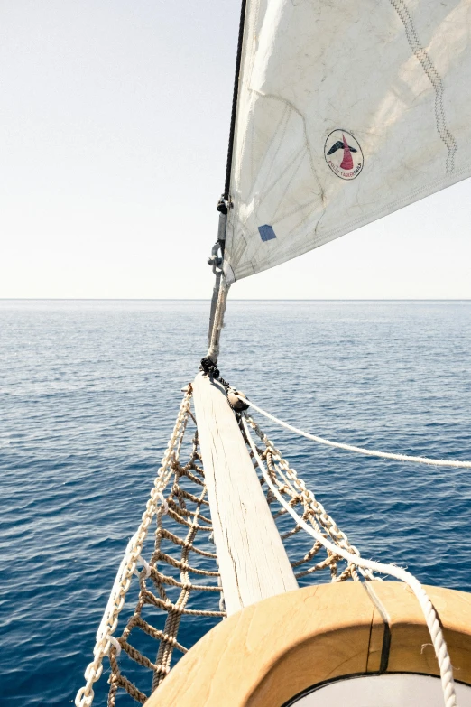 a sail boat in the middle of the ocean, rope bridges, helmet view, over the head of a sea wolf, lined in cotton