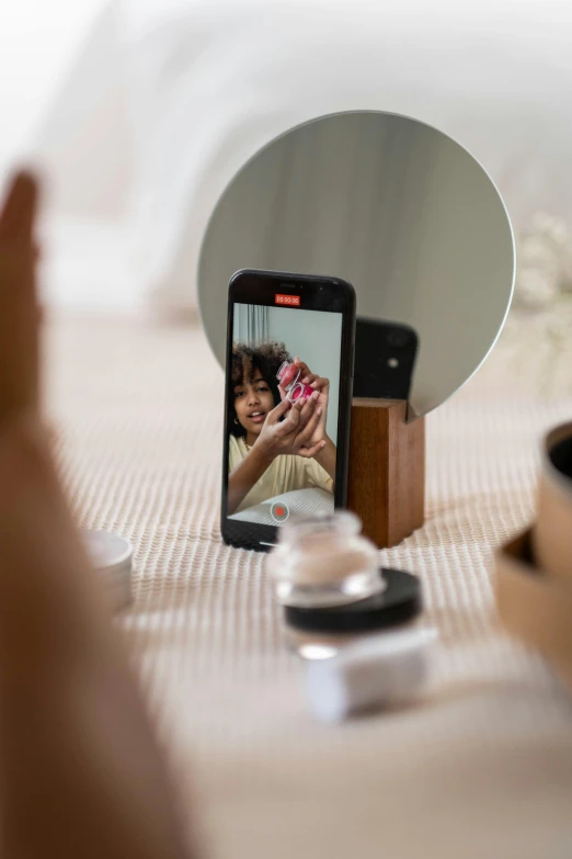 a person taking a picture of themselves in a mirror, textured base ; product photos, morning, sharp focus »