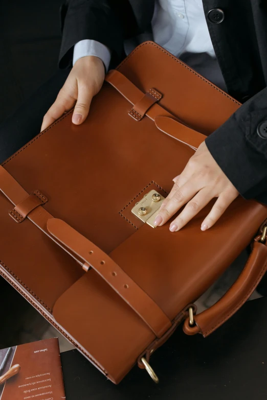 a close up of a person holding a briefcase, inspired by Eugène Brands, amber, top down shot, opening, high-body detail
