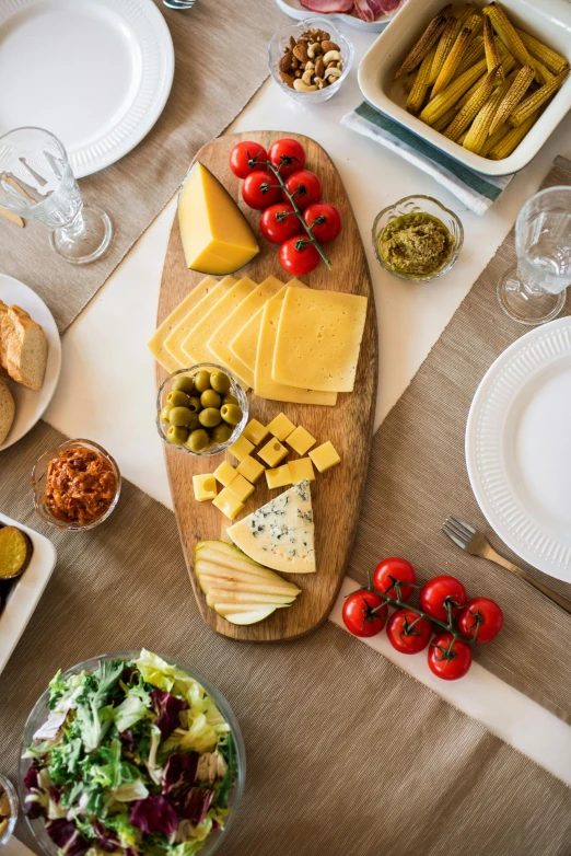 a table topped with lots of different types of food, a picture, by Matthias Stom, shutterstock contest winner, extra cheese, natural wood top, mediterranean, yellow