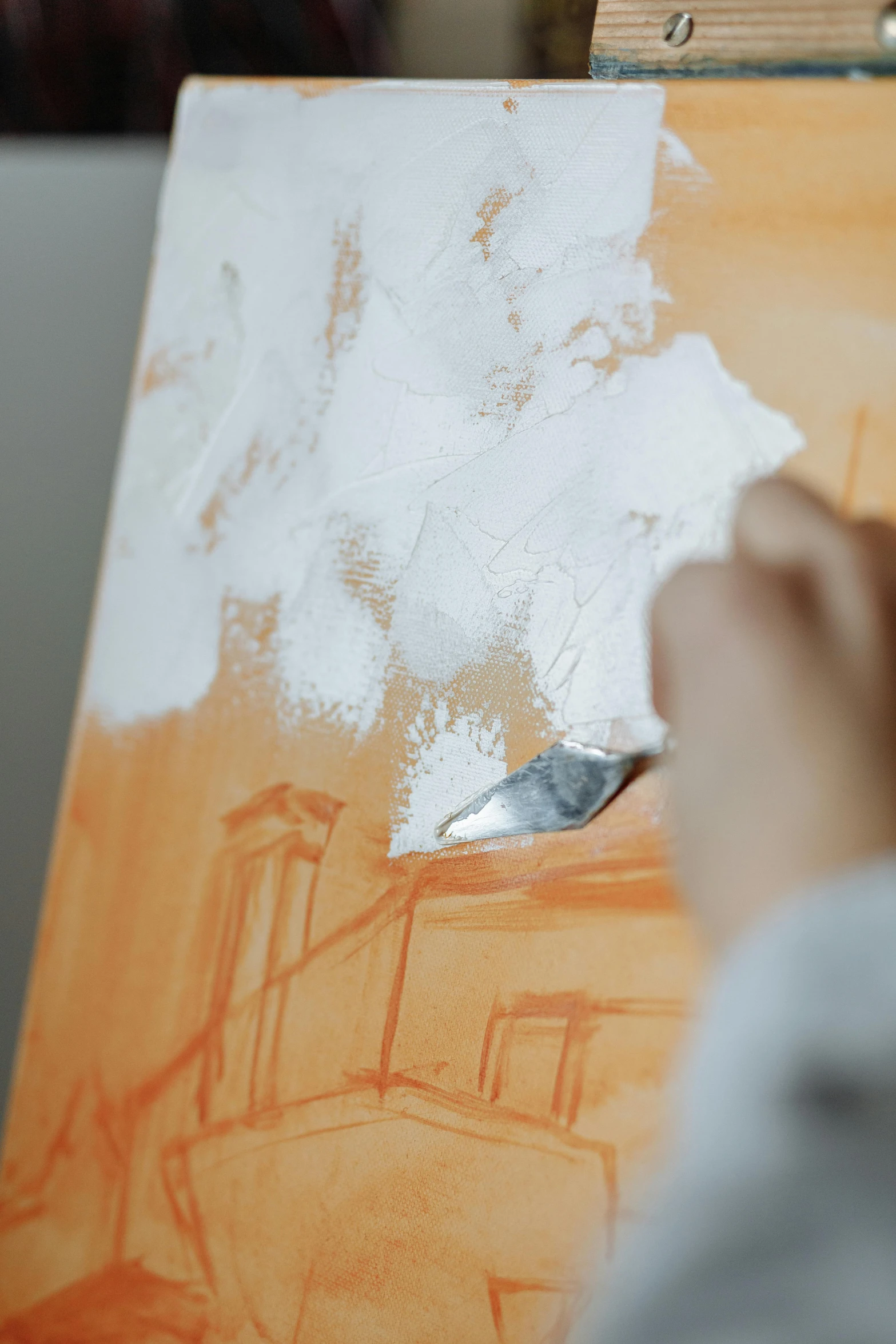 a person is painting a picture on an easel, a painting, inspired by Emil Carlsen, trending on pexels, white and orange, paint knife, creating a soft, a painting of white silver