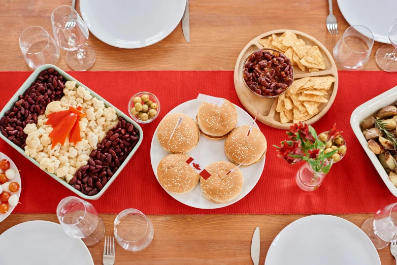 a wooden table topped with plates of food, by Carey Morris, pexels, private press, white and red color scheme, square, holiday, 6 pack