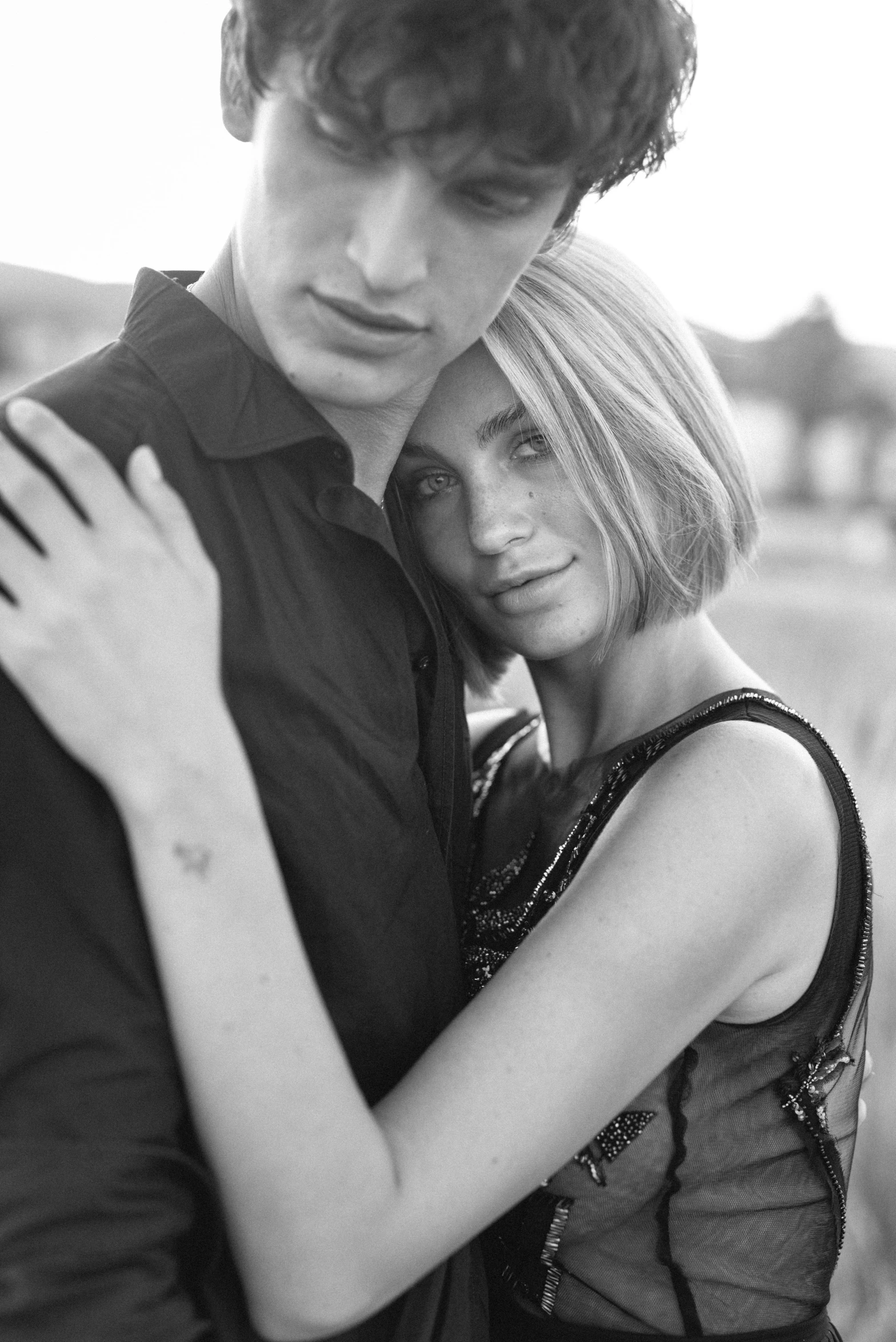 a man and a woman hugging in a field, a black and white photo, by Zofia Stryjenska, handsome face and beautiful face, medium format, 15081959 21121991 01012000 4k