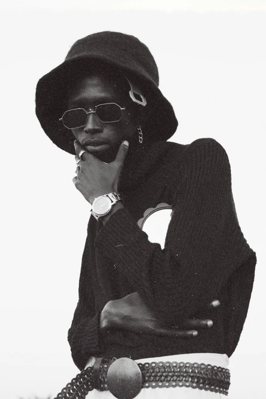 a black and white photo of a man smoking a cigarette, an album cover, trending on pexels, neo-dada, adut akech, wearing sunglasses and a cap, 1996), androgynous person