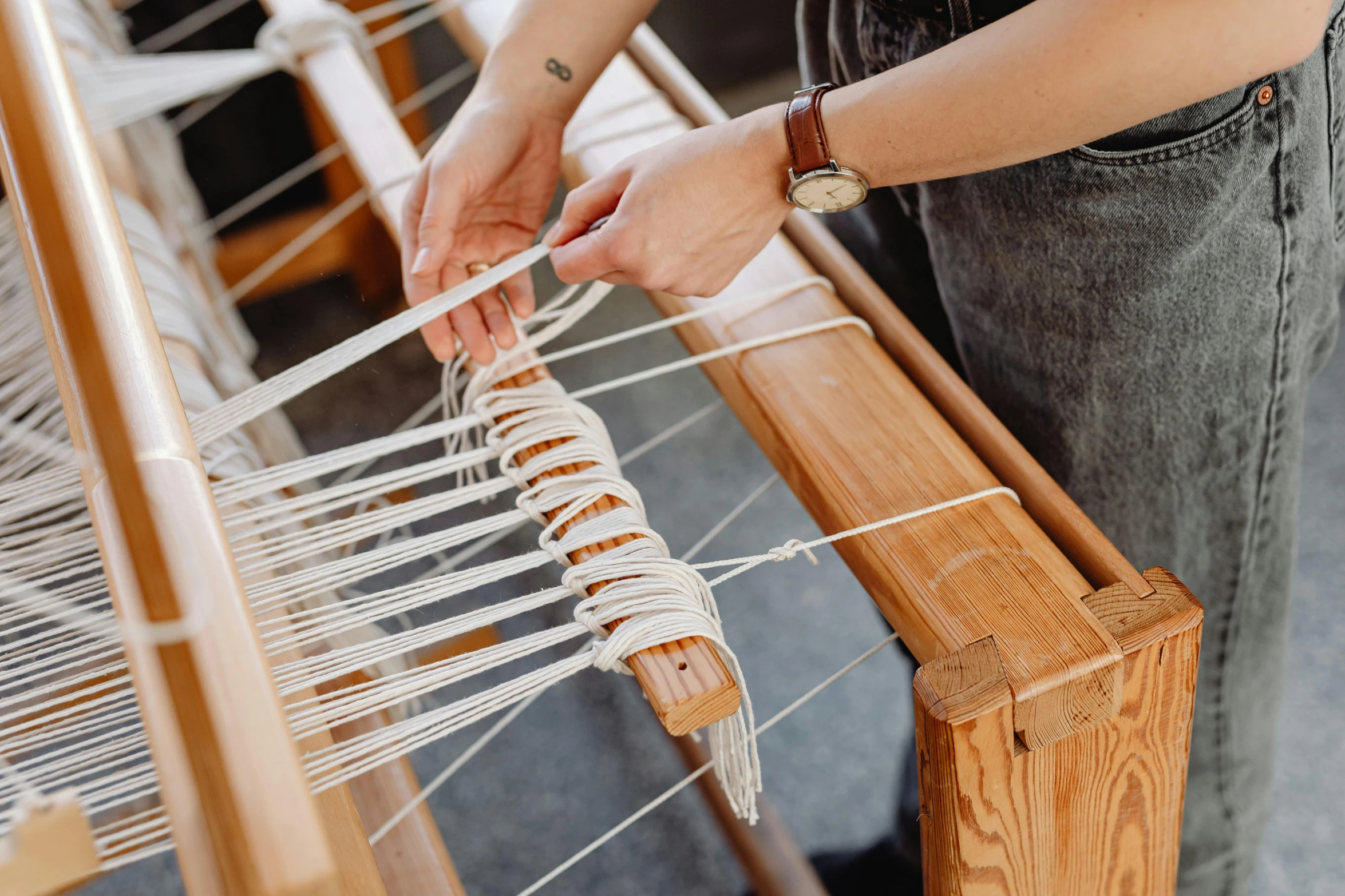 a woman is working on a weaving machine, trending on pexels, hands pressed together in bow, holding a wooden staff, walking down, thumbnail