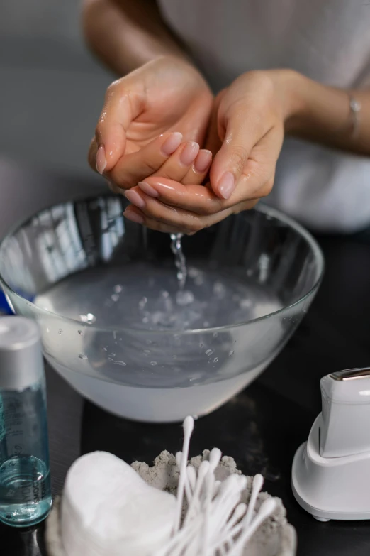 a person washing their hands in a bowl, hot glue, bubbling liquids, enhancements, bumps