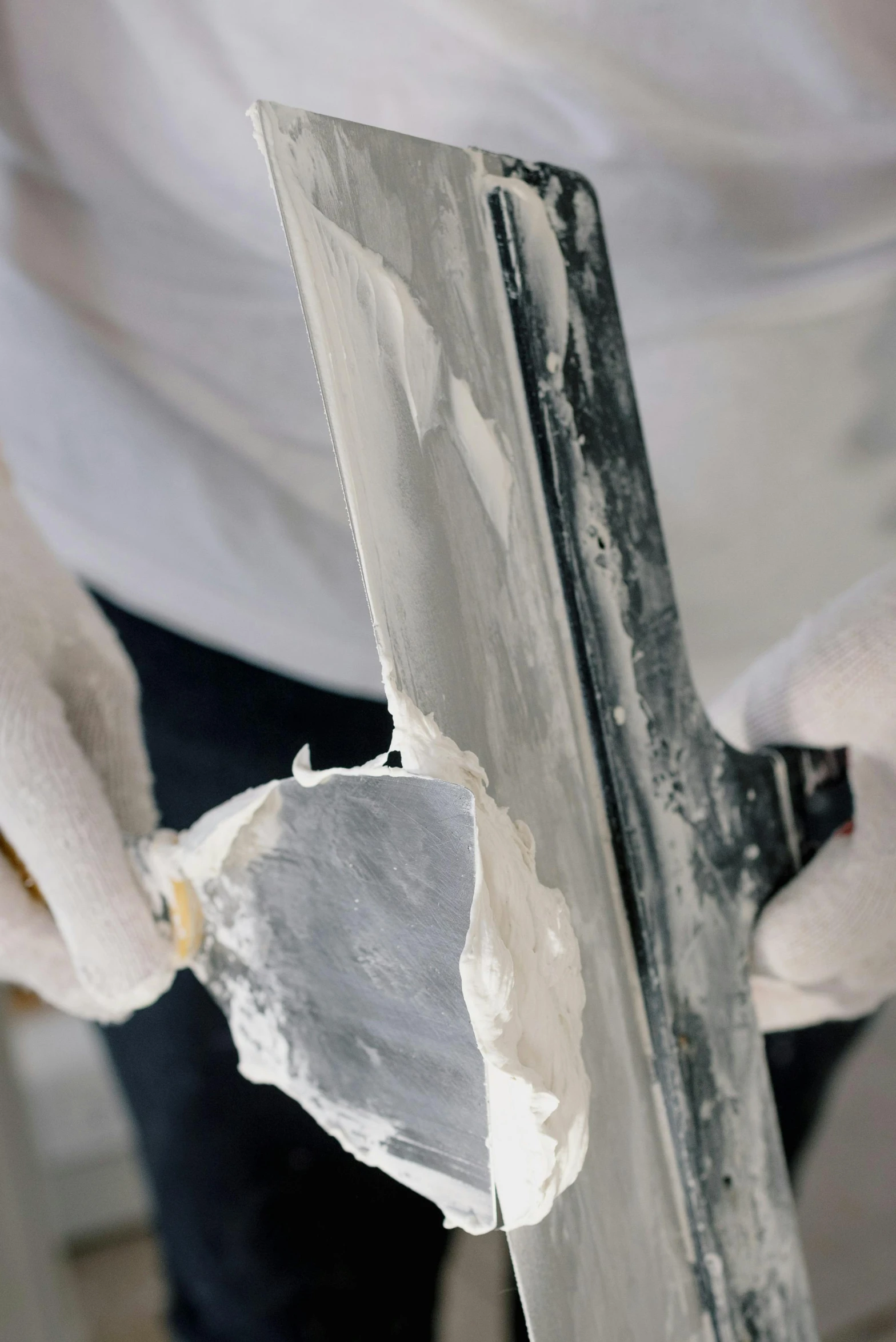 a person in white gloves holding a knife, a marble sculpture, inspired by Patrick Pietropoli, gutai group, restoration, grey, up close, visible paint layers