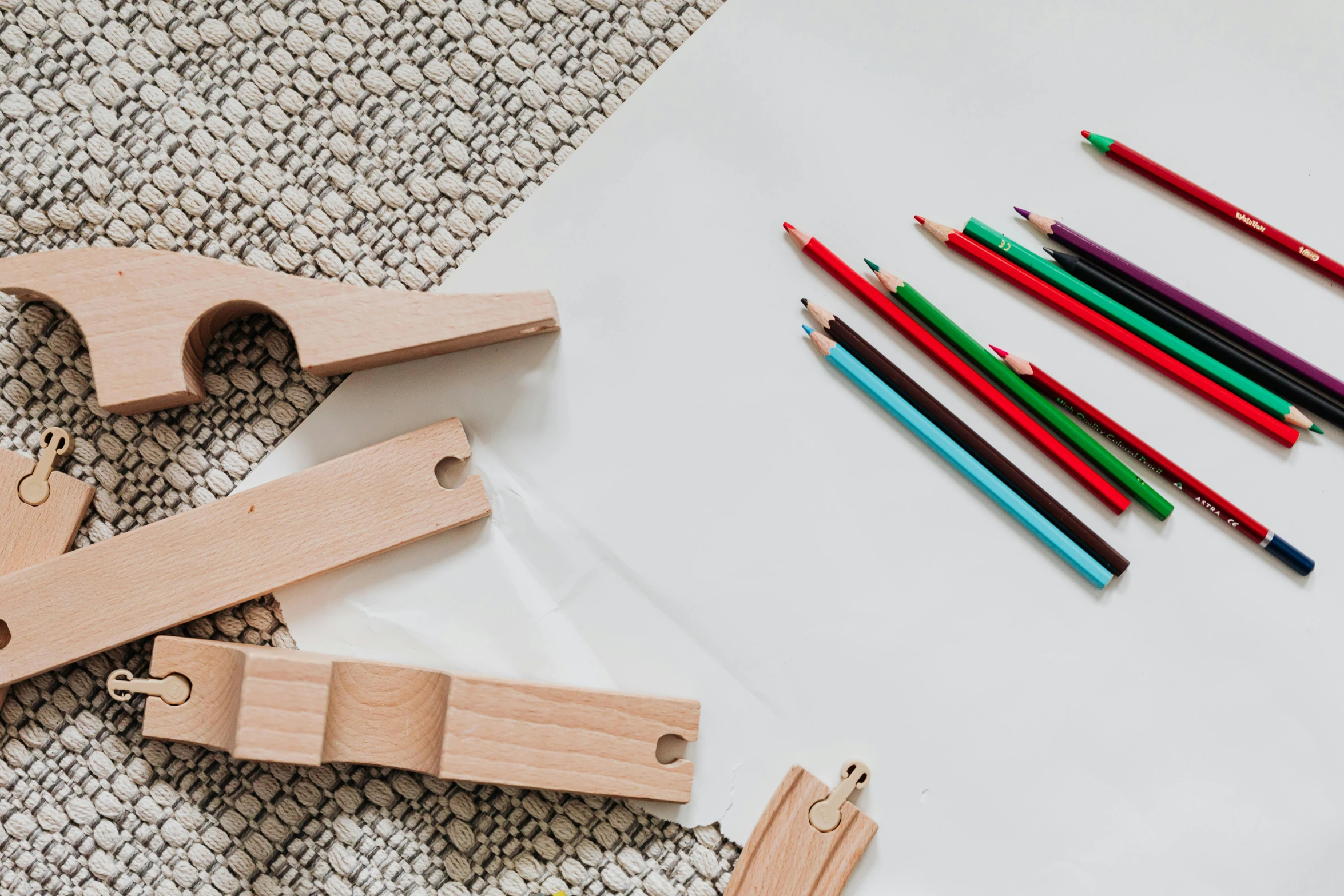 a group of colored pencils sitting on top of a table, a child's drawing, inspired by W. Lindsay Cable, trending on pexels, intricate leather suspenders, wooden supports, product introduction photo, toy guillotine