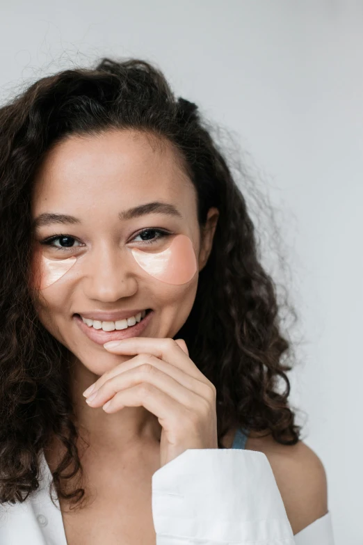 a woman in a white shirt posing for a picture, trending on pexels, renaissance, a plaster on her cheek, mixed race, outline glow, joyful look