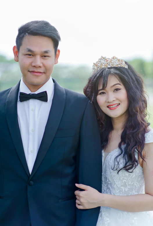 a man and a woman standing next to each other, crown and gown, half asian, professional photo-n 3, trending photo