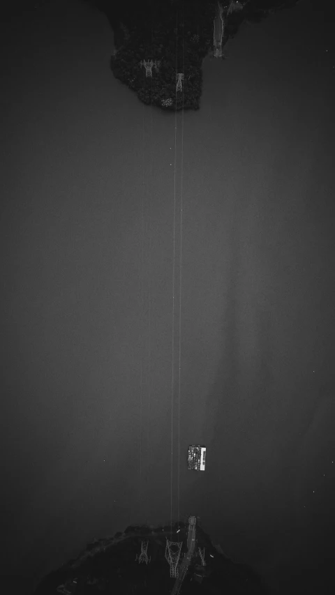 a black and white photo of a clock in a room, an album cover, by Robert Mapplethorpe, unsplash, postminimalism, dark grey robes, studio medium format photograph, curtain, holding a staff