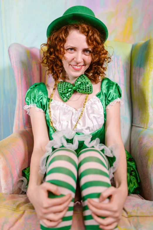 a woman in a green outfit sitting in a chair, inspired by Ron English, flickr, renaissance, curly haired, alice attends mad tea party, irish youtuber, cosplay photo