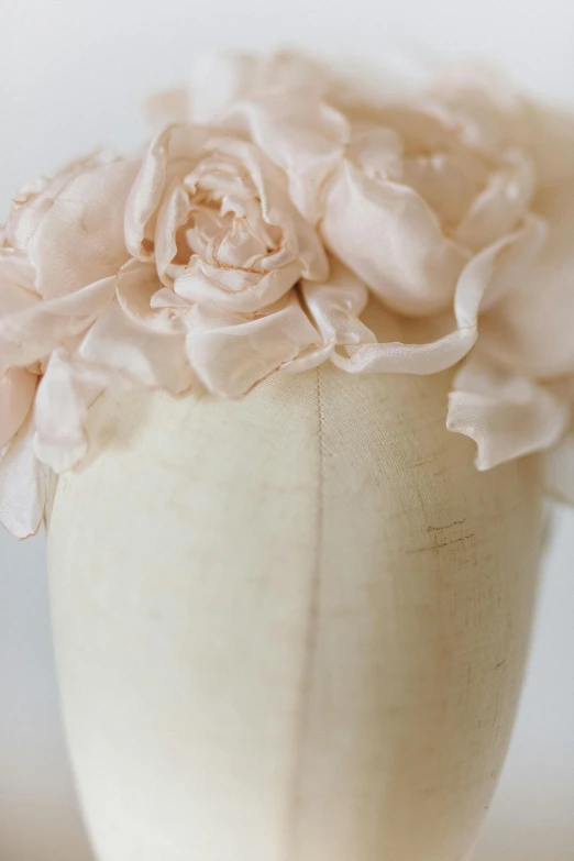 a close up of a vase with flowers in it, organic headpiece, chiffon, faded pink, uncropped