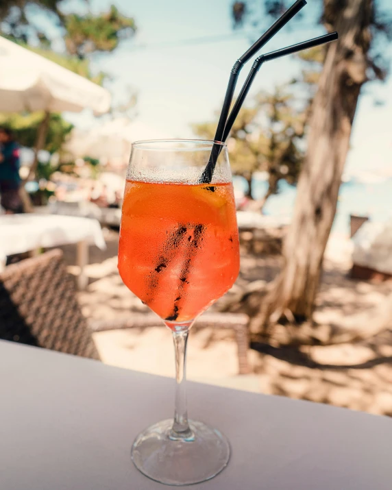 a drink sitting on top of a white table, by Carey Morris, pexels contest winner, beach trees in the background, profile image, mediterranean, thumbnail