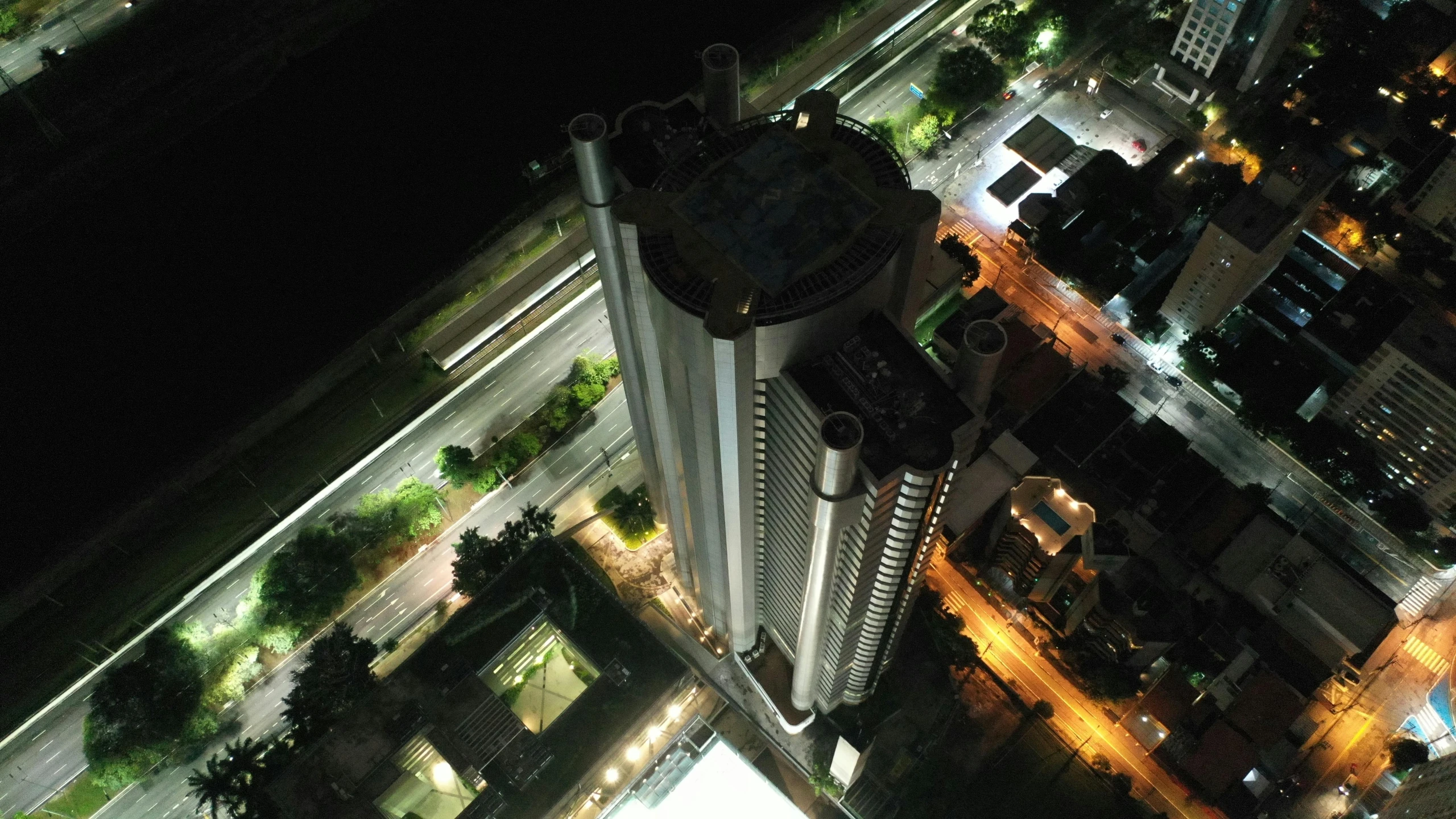 an aerial view of a city at night, an album cover, pexels contest winner, photorealism, city high-rise, sao paulo, architectural model, high angle vertical