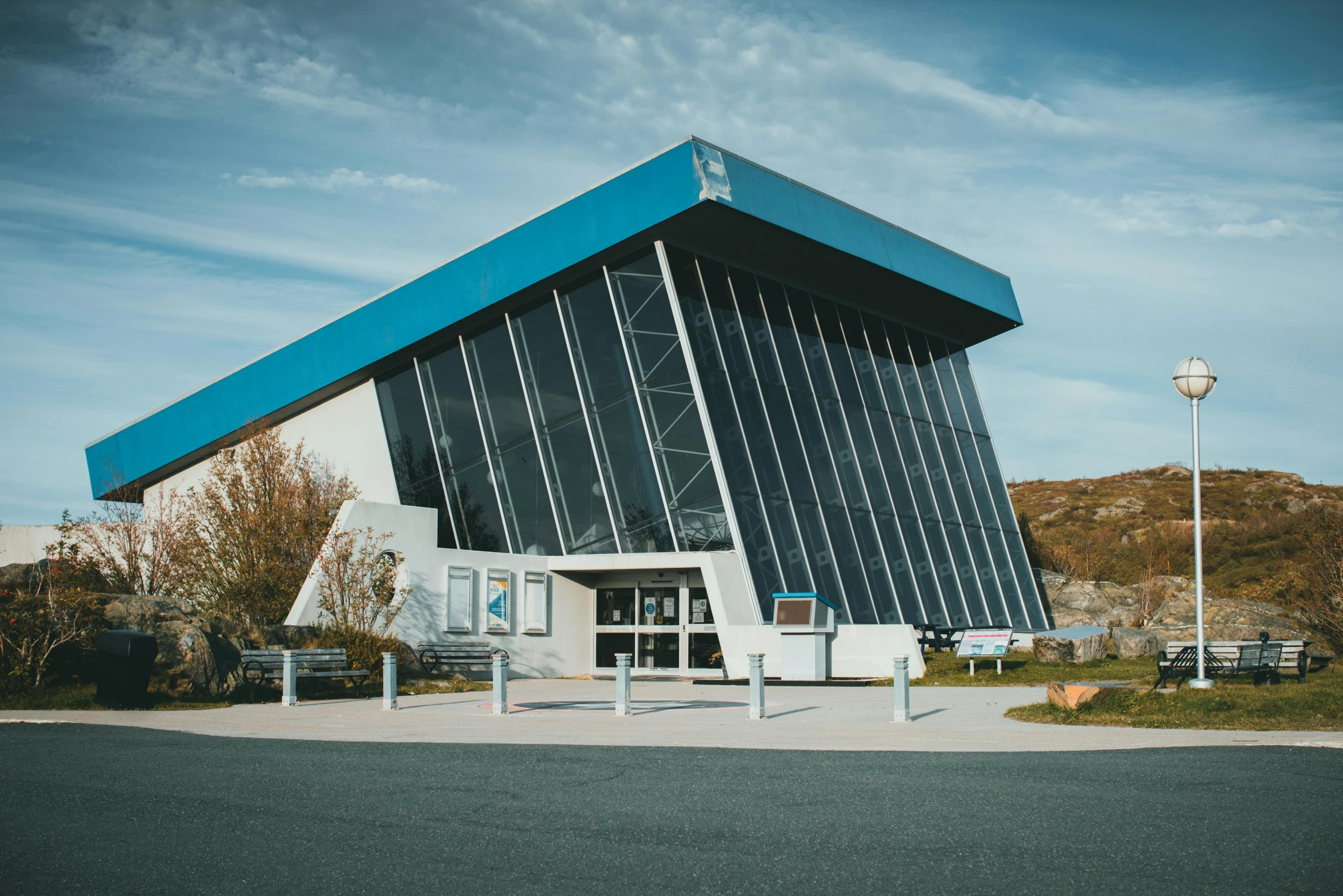 a blue and white building sitting on the side of a road, spaceport, eeyrie, slate, iconic scene