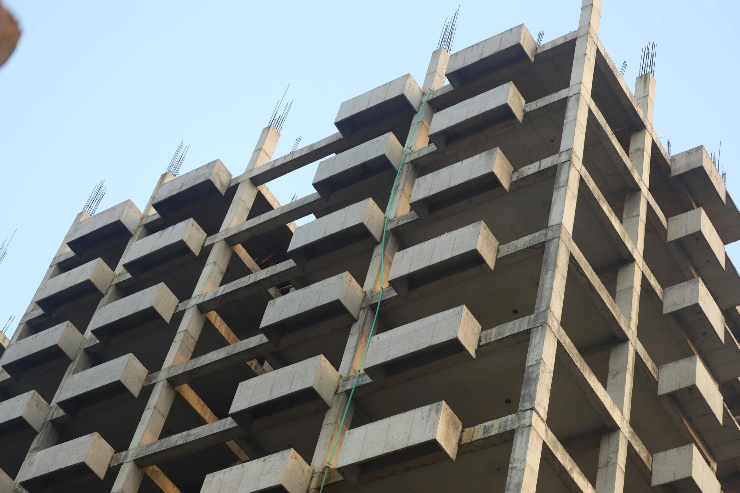 a very tall building that is under construction, unsplash, brutalism, vinayak, front top side view, square jaw-line, parapets