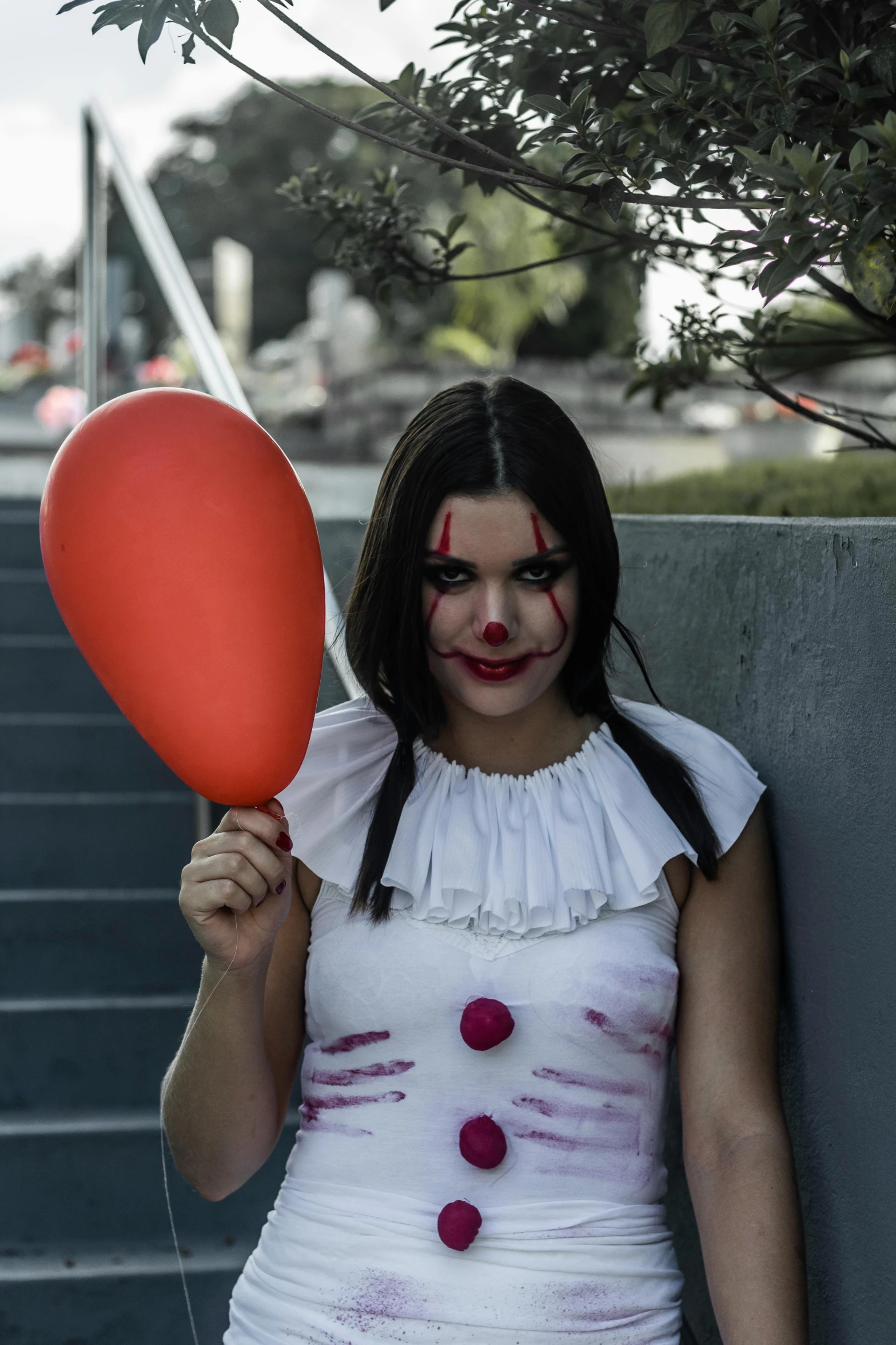 a woman dressed as a clown holding a balloon, pexels contest winner, with haunted eyes and dark hair, hailee steinfeld, pennywise theme, ( ( theatrical ) )