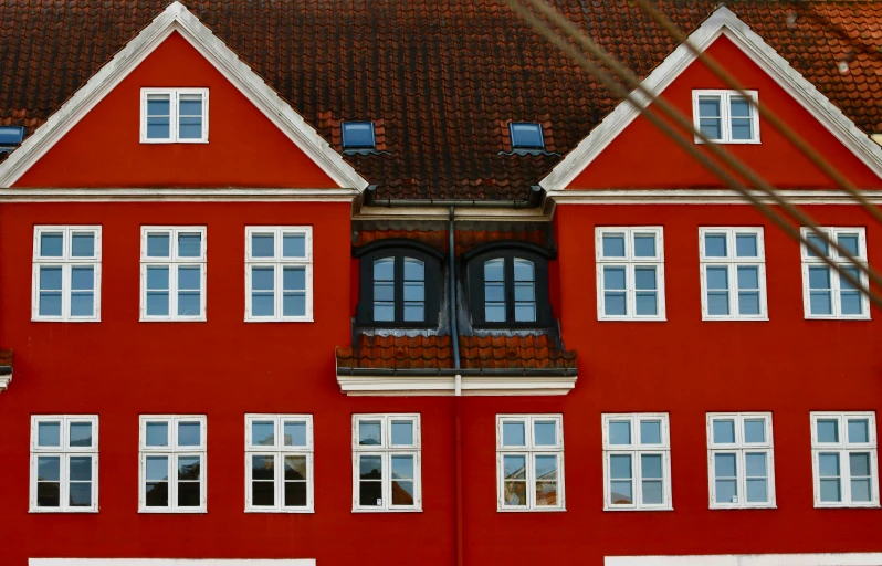 a red building with a clock in front of it, by Christen Dalsgaard, pexels contest winner, hyperrealism, simple gable roofs, house windows, symmetrical front view, windows and walls :5