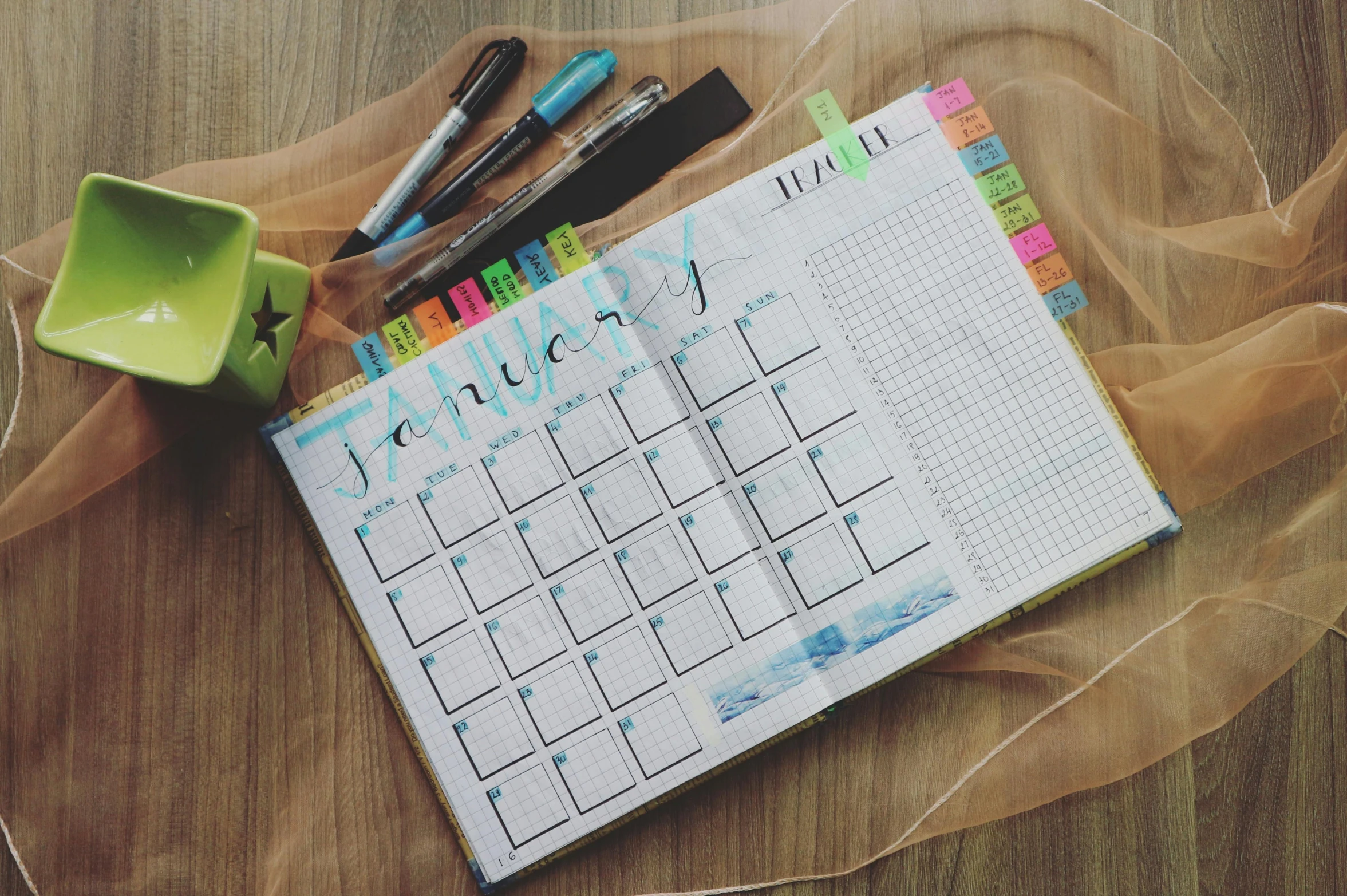 a calendar sitting on top of a wooden table, by Carey Morris, pexels contest winner, markers, grid layout, student, square