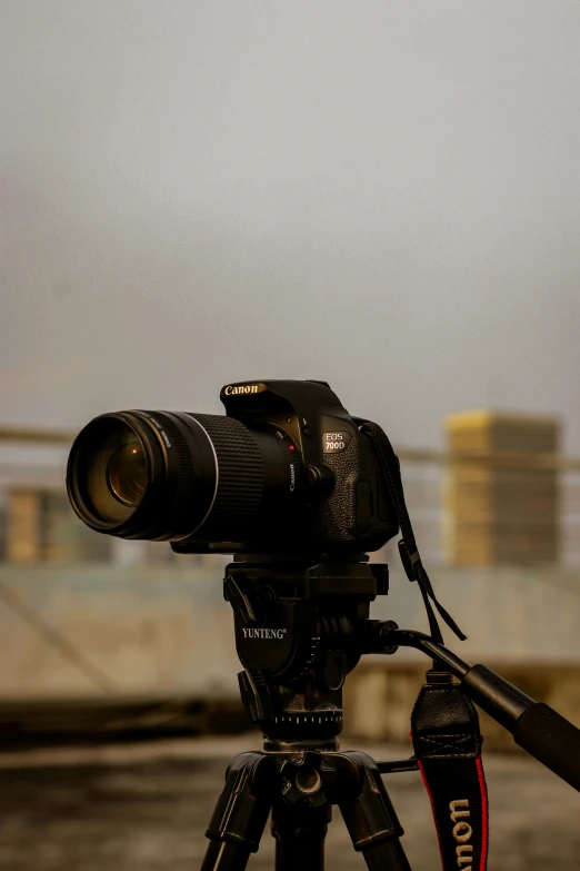 a camera sitting on top of a tripod, by Carey Morris, skyline view from a rooftop, overcast!!! cinematic focus, headshot, high speed camera