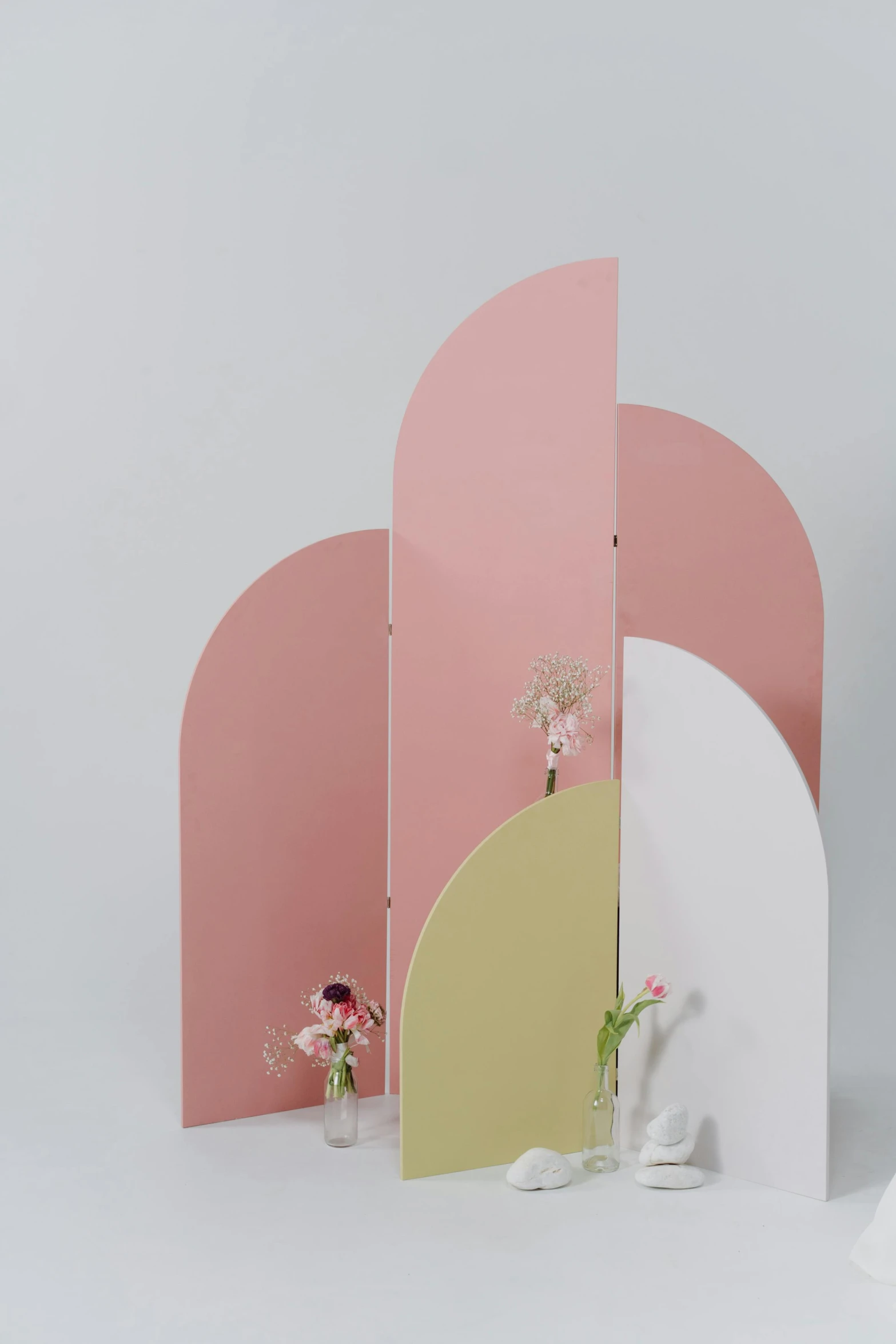a couple of white vases sitting on top of a table, pink arches, translucent pastel panels, model photograph, laser cut