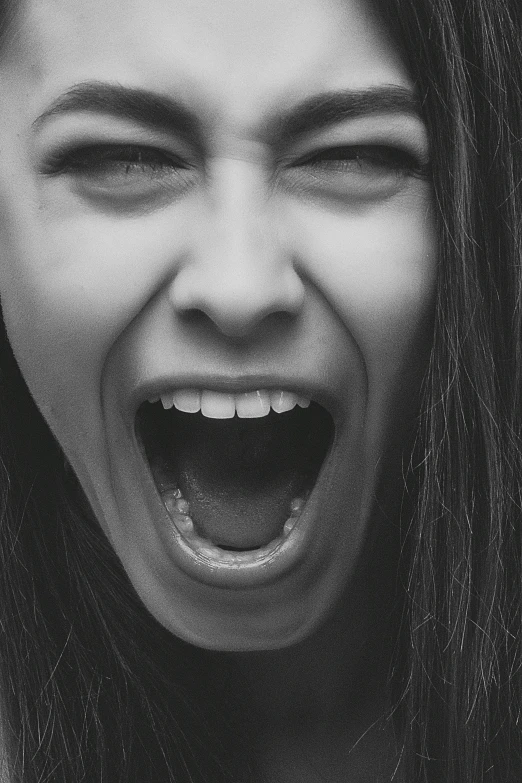a black and white photo of a woman with her mouth open, pexels, girl screamin yolo - aesthetic, clenching teeth, young angry woman, and