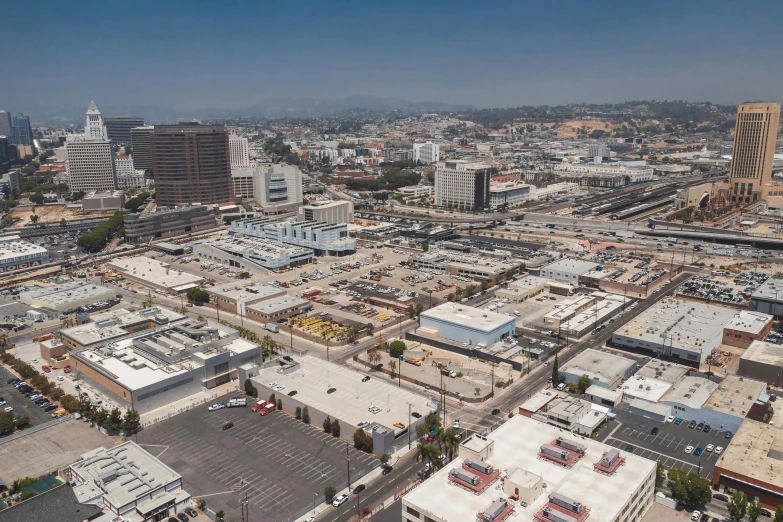 an aerial view of a city with lots of buildings, by Arnie Swekel, unsplash, photorealism, 1600 south azusa avenue, square, 4k photo gigapixel, crane shot