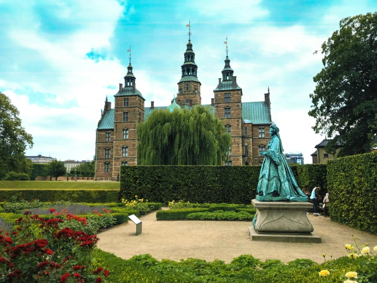 a statue of a woman standing in front of a castle, by Jesper Knudsen, pexels contest winner, the city is full of green plants, black domes and spires, thumbnail, denmark