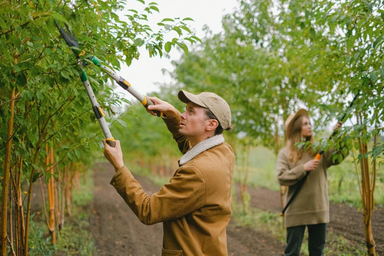 a couple of people that are standing in the dirt, fruit trees, holding a crowbar, profile image, maintenance photo