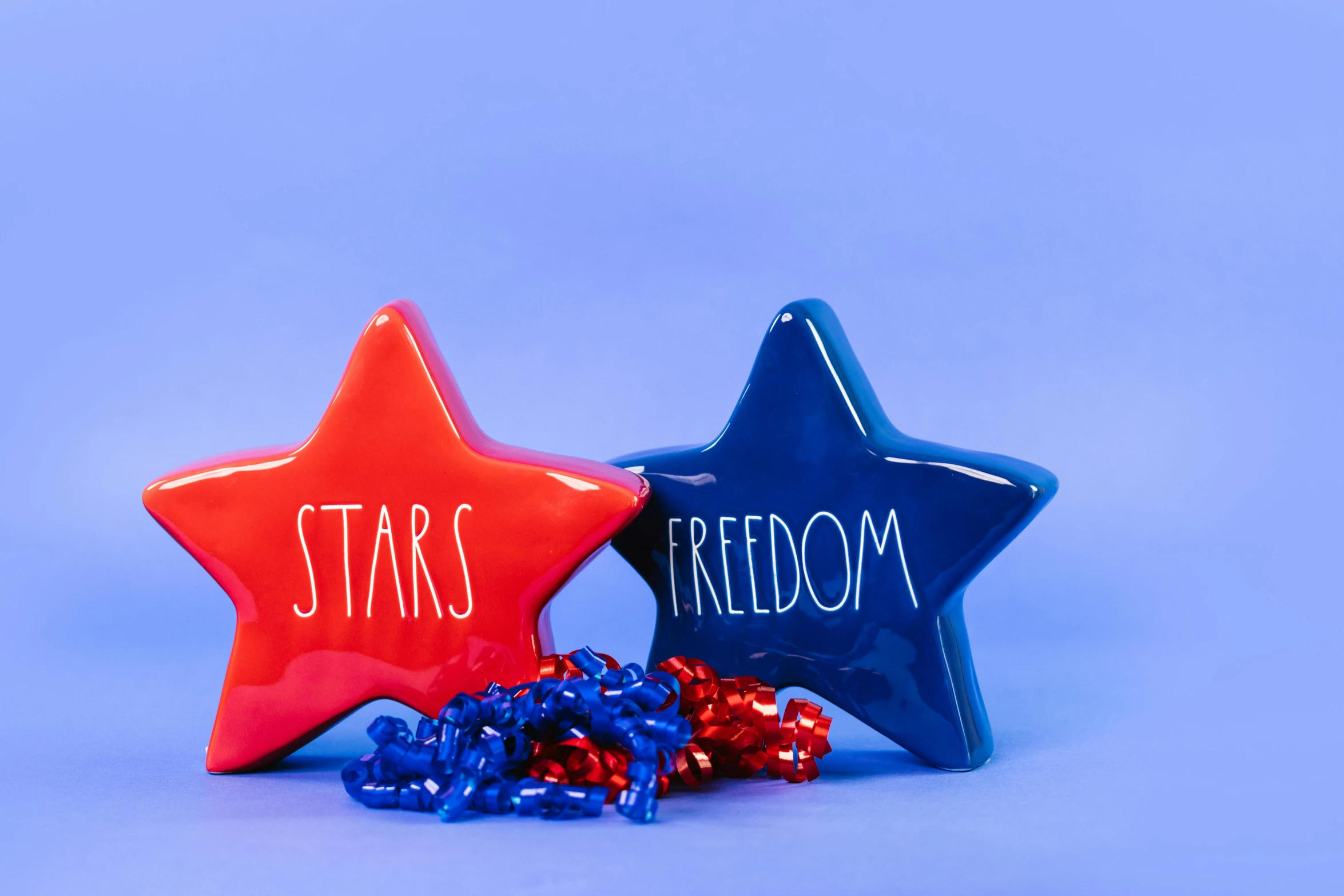 two red, white and blue stars sitting next to each other, an album cover, pexels, freedom, dipped in polished blue ceramic, snacks, background image